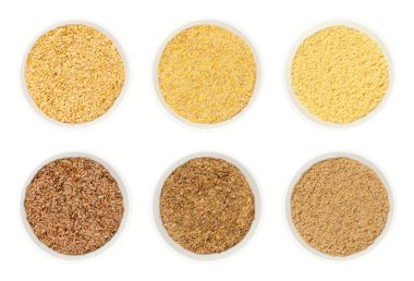 Beyaz kâselerde altın ve kahverengi keten tohumları. Linum usitatissimum, Omega-3 yağ asitleri bakımından zengin, besin takviyesi olarak ya da keten tohumu yağı olarak kullanılır..