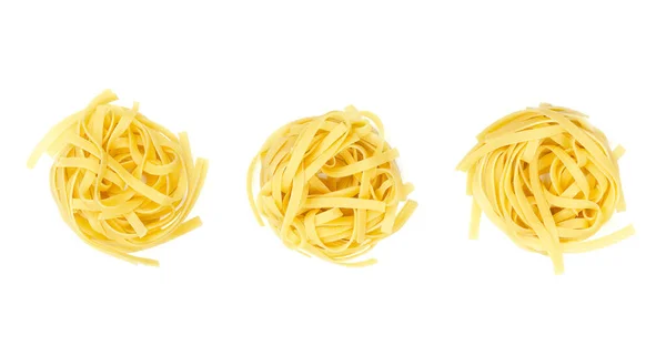 Three Uncooked Tagliatelle Pasta Nests Row White Background Dried Raw — стоковое фото