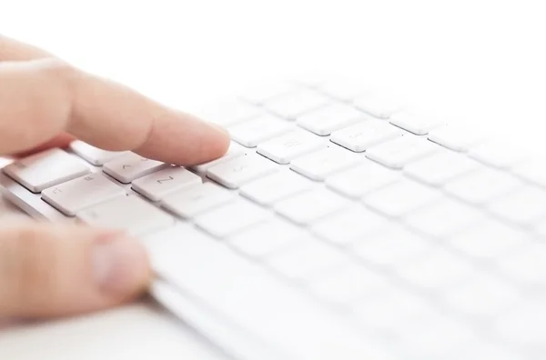 Human hand working on a computer keyboard — Stock Photo, Image