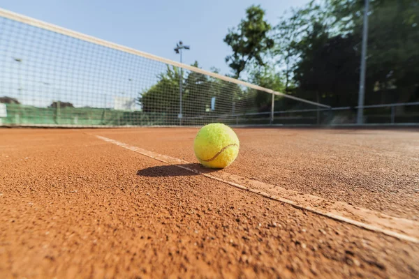 Tennis ball on clay court — Stock Photo, Image