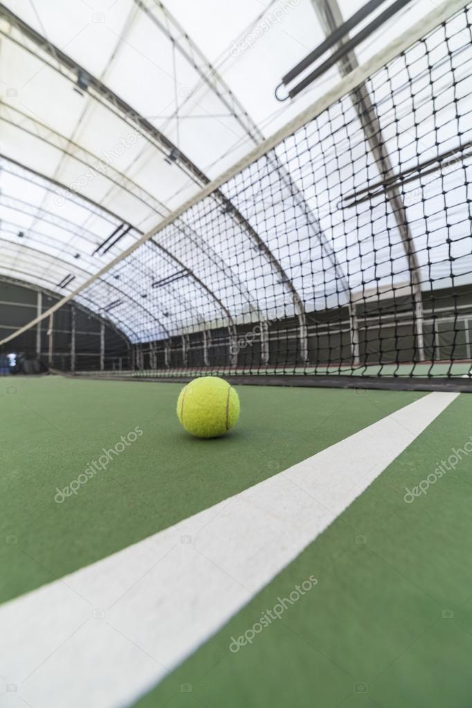 Tennis ball in indoor tennis court