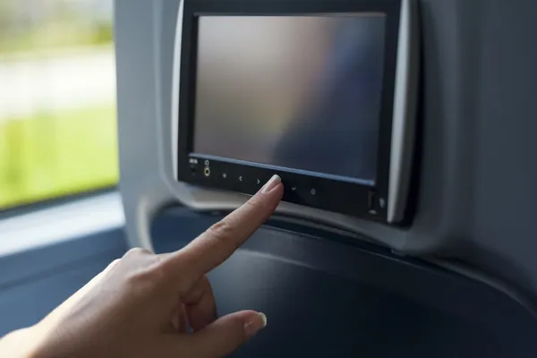 Mujer tocando la pantalla multimedia en el autobús — Foto de Stock