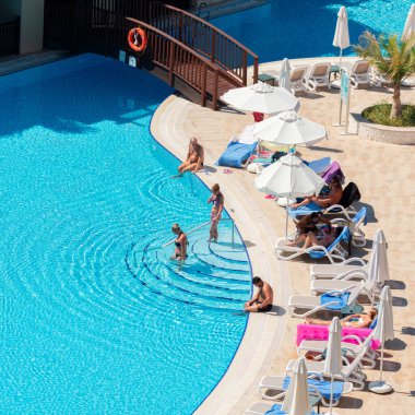 Antalya, Turkey-October 09, 2017: People swimming in the swimming pool, sunbathing in hotel in a summer day. Antalya a main summer destination for Russian, Ukrainian, British and German tourists.