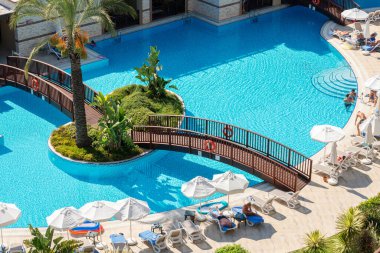 Antalya, Turkey-October 07, 2017: People swimming in the swimming pool, sunbathing and doing other activities in hotel in a summer day. Antalya popular destination for Russian and Ukrainian tourists.