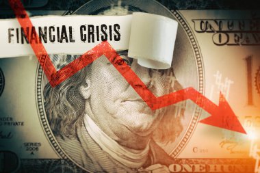 Financial Crisis word under the torn dollar bill.  Economist forecast for the United States. Glowing red arrow going downwards on Benjamin Franklin portrait.  US economy, inflation, crisis and reccssion concept.