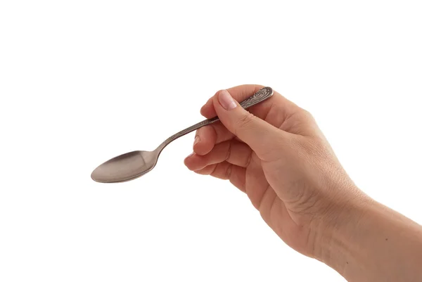 Teaspoon in a female hand Stock Image