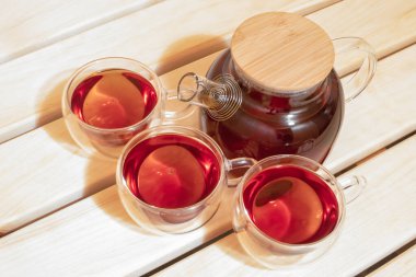 Cam çaydanlık ve fincanlar saunadaki ahşap rafta duruyor.