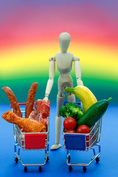 Conceptual man, meat, vegetables,on bright rainbow background — Stock Photo, Image
