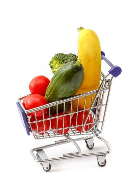 Mixed fruit and vegetables in a mini shopping cart, isolated on