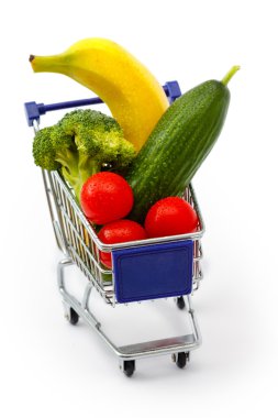Mixed fruit and vegetables in a mini shopping cart, isolated on