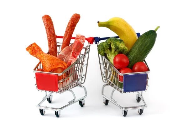 Meat and vegetables in two shopping carts, isolated on white — Stock Photo, Image