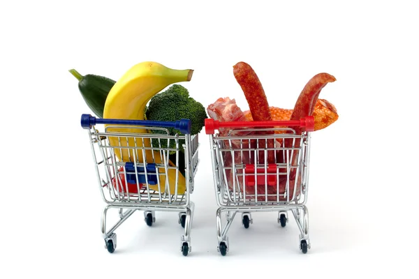 Meat and vegetables in two shopping carts, isolated on white — Stock Photo, Image