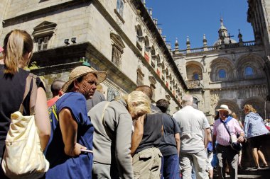 Catholic pilgrims wait their turn for visiting St. James Cathedral on Saint James Day in Santiago, Spain. clipart