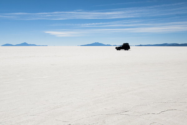 Jeep in salt desert Uyuni, Bolivia.