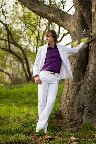 Handsome man wearing bouquet of flowers — Stock Photo, Image