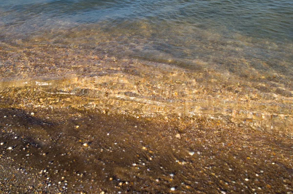 Våg och stranden sand — Stockfoto