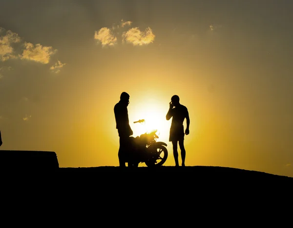 Silhouette of a motorcyclist on a background of dark sky — Stock Photo, Image