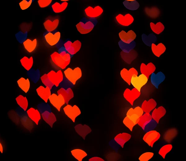 Luzes de fundo desfocadas ou bokeh na forma de coração — Fotografia de Stock