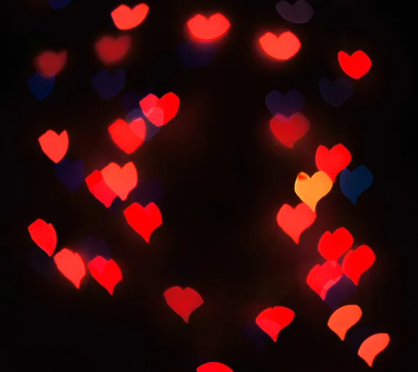 Luces de fondo desenfocadas o bokeh en forma de corazón —  Fotos de Stock