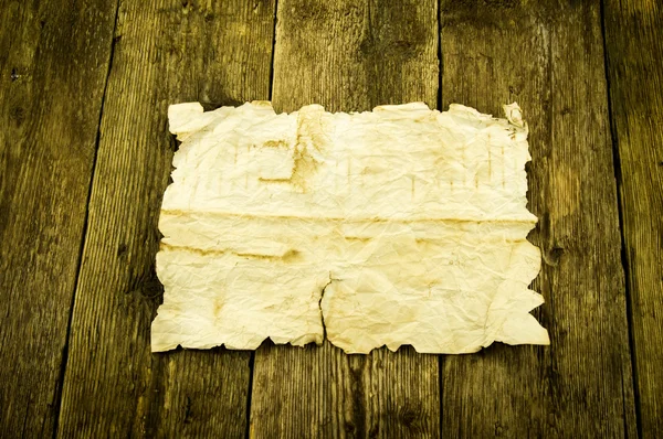 Old paper on wood background — Stock Photo, Image