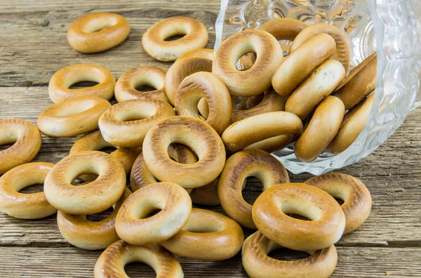 Closeup of a group of assorted bagels on a wood table top with b — Stock Photo, Image