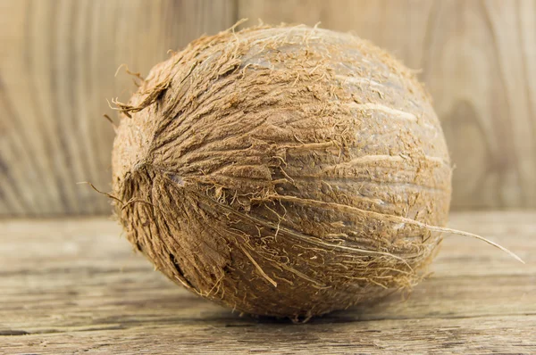 Whole fresh coconut over wooden background — Stock Photo, Image