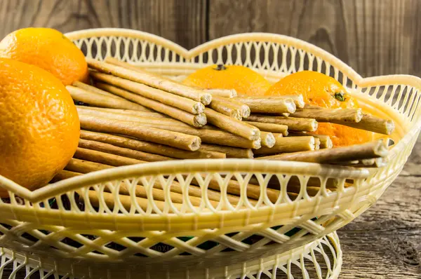 Breadsticks and mandarins on wooden background — Stock Photo, Image