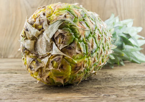 Pineapples on wooden grunge background — Stock Photo, Image