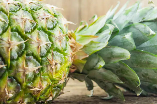 Pineapples on wooden grunge background — Stock Photo, Image