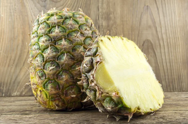 Pineapples on wooden grunge background — Stock Photo, Image