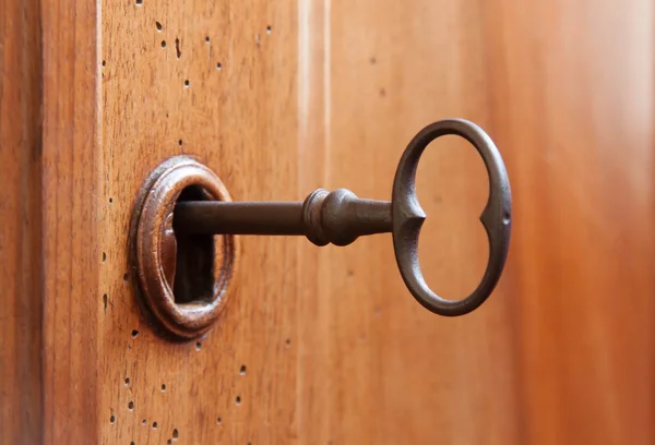 Old key in a keyhole — Stock Photo, Image