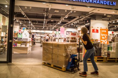 Stockholm, Sweden A person pushes a load of book crates into the Akademibokhandeln chain of bookstores in the Morby Centrum shopping mall in Danderyd.