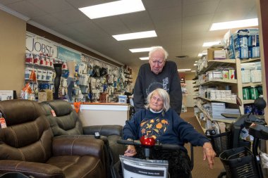 Solomons, Maryland USA  A senior couple shop for an electric wheelchair or scooter.