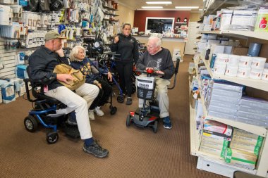 Solomons, Maryland USA  A senior couple shop for an electric wheelchair or scooter.