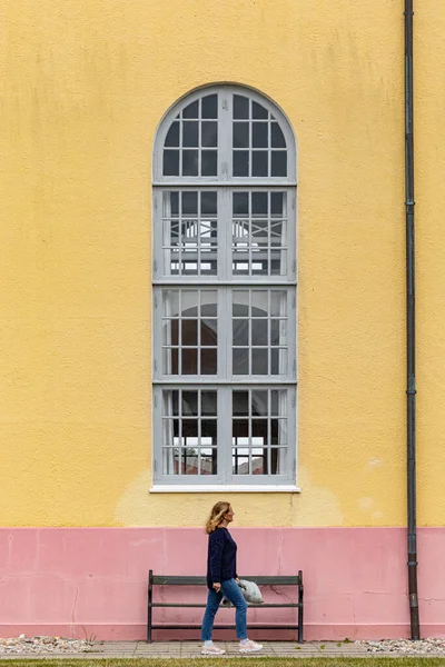 Skagen, DenmarkA woman walks past the facade of the  Skagen kirke or Skagen Church.
