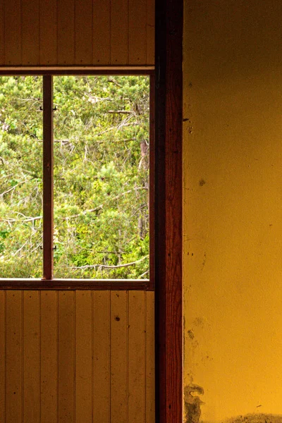 Stockholm, Sweden The inside of an abandoned house and a yellow wall.