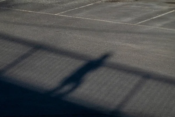 Stockholm, Sweden A shadow of a man walking over a bridge.