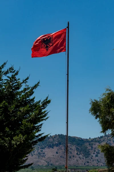 Ksamil, Albania The Albanian flag flowing in the wind.