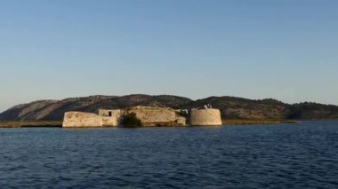 Ksamil, Albania A small motorboat approaches the Ali Pasha Castle on the coast.