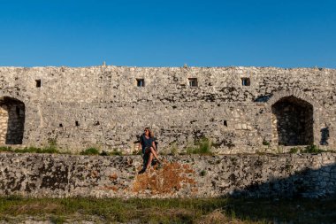 Ksamil, Albania A woman tourist visits the Ali Pasha Ottoman castle at the inlet of Lake Butrint.