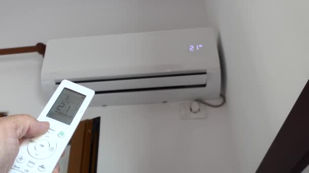 Man Uses Remote Control Adjust Air Conditioning — Vídeos de Stock