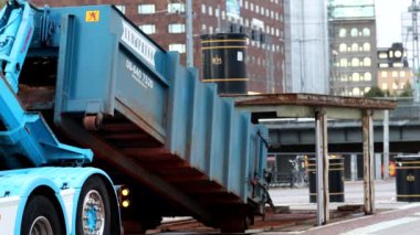 Stockholm, Sweden A truck installs a garbage container for an underground garbage collection system in front of City Hall. 