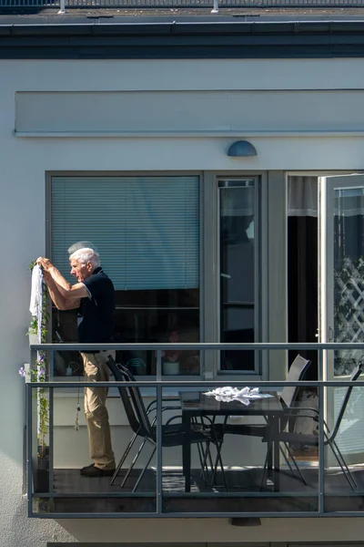 Stockholm Sweden Senior Man Tends His Blacony Modern Building — стоковое фото