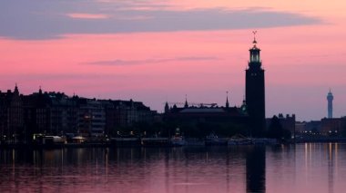 Stockholm, Sweden The City Hall or Stadshuset at dawn reflected in Riddarjarden.