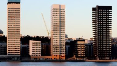 Stockholm, Sweden The sun rises over the Liljeholmskajen neighborhood with high-rise apartment buildings. 