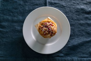 A breakfast muffin on a plate
