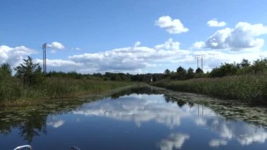 Faringso, Sweden A small motorboat navigates a narrow channel.