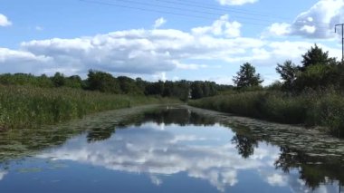 Faringso, Sweden A small motorboat navigates a narrow channel.