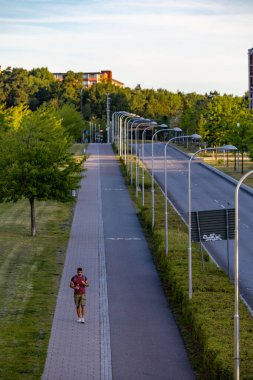 Stockholm, Sweden A man walks on a path in the Kista district, a high tech hub.