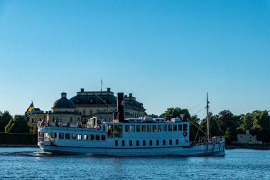 Stockholm, Sweden A ferry drives past the Royal Palace of Drottnigholm on a summer day.